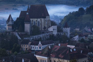 The medieval Saxon village of Biertan and his fortified church seen at the blue hour. Photo taken on 4th of October 2020 in Biertan, Sibiu county, Romania. clipart