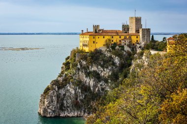 Duino Castle overlooking the Gulf of Trieste on the Adriatic Sea. Photo taken on 28th of November 2022 in Duino village, Trieste province, Italy. clipart