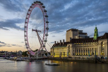 Gün batımında dramatik bir gökyüzünün altında Londra Gözü 'nün görüntüsü. Fotoğraf 11 Haziran 2022 'de Londra, İngiltere' de çekildi..
