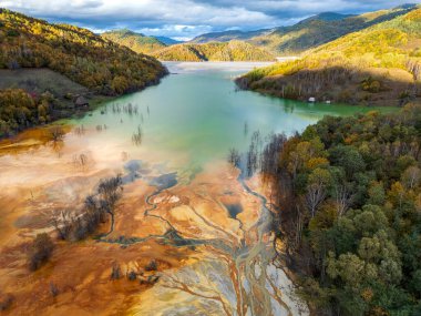 Aerial view of Geamana lake, a water body formed from the toxic waste of copper and gold mining. Drone photo taken on 12th of October 2024 on the Geamana lake, near Rosia Montana, Romania. clipart