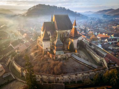 The medieval Saxon village of Biertan and its fortified church during a dreamy morning. Photo taken on 29th of December 2023 in Biertan, Sibiu County, Romania. clipart