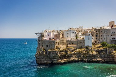 Beautiful view of Polignano a Mare, Metropolitan City of Bari, Apulia, Italy, showing seaside cliffs and historic buildings above turquoise water, captured on June 22, 2025.