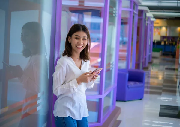 Mobile phone in her hand is a constant reminder of the importance of staying connected in the business world, Digital marketing.
