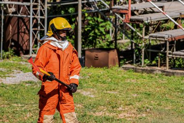 Dış mekan, yangın ve yıkım güçleriyle savaşmaya hazır bir şekilde balta üzerinde ilerlerken itfaiyecinin görev ve dayanıklılığını arttırıyor..