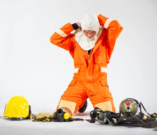Firefighters Kneeling Removing His Hoods Placing Them Equipment Floor White — Stock Photo, Image