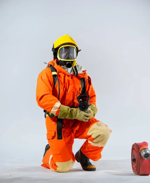 Firefighter Sitting Kneel Holding Fire Hose While Looking Camera White — Stock Photo, Image