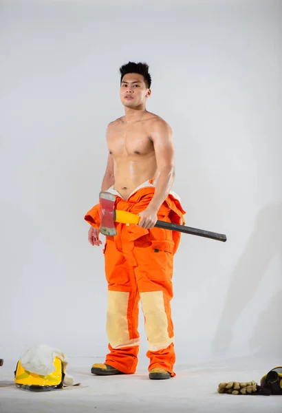 stock image Topless firefighter's confident stance and unwavering gaze convey a sense of assurance and competence reflecting the extensive training and experience.