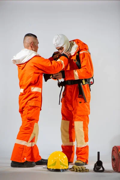 Professional Firefighter Carefully Adjusts His Partner Mask White Background — Stock Photo, Image