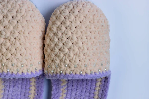 A close-up view of the knitted slippers. Needlework, knitting