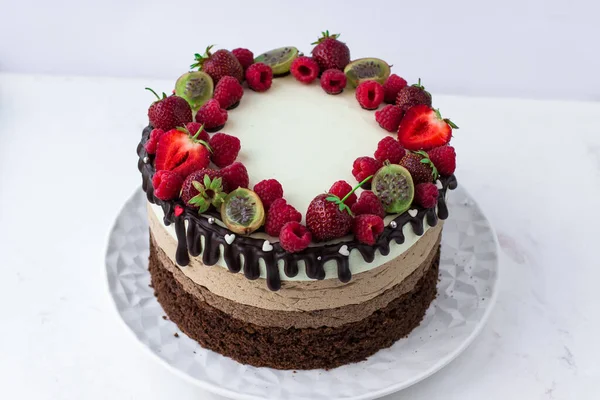 Cake three chocolates with strawberries, raspberries and gooseberries