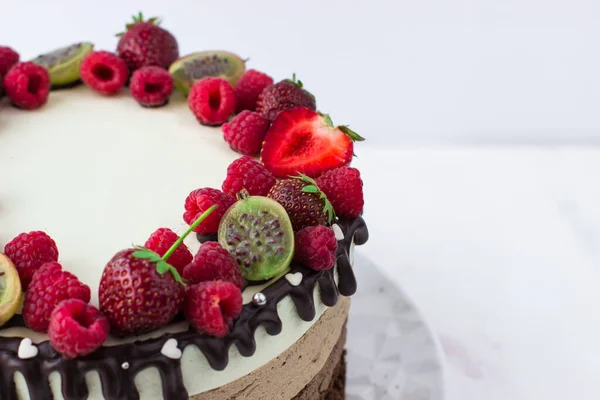 Cake three chocolates with strawberries, raspberries and gooseberries