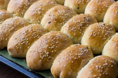 Üzerine susam tohumu serpiştirilmiş ev yapımı turtalar. Ev yapımı iştah açıcı kekler.