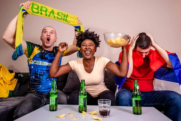 stock image Friends watching a football match on TV cheering for their national team. World cup in soccer. Brazil fans.