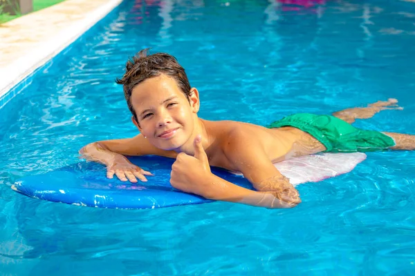 Cute Smiling Child Boy Paddling Surf Board Pool Showing Thumb — Stock Photo, Image