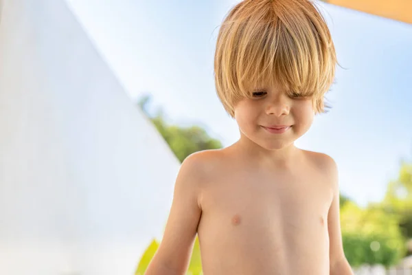 Stock image Portrait of cute child blond boy in a summer day outdoors.