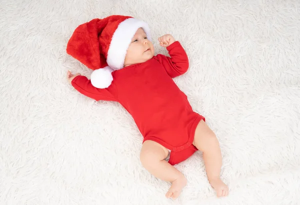 stock image cute newborn baby girl with santa hat lying outdoors