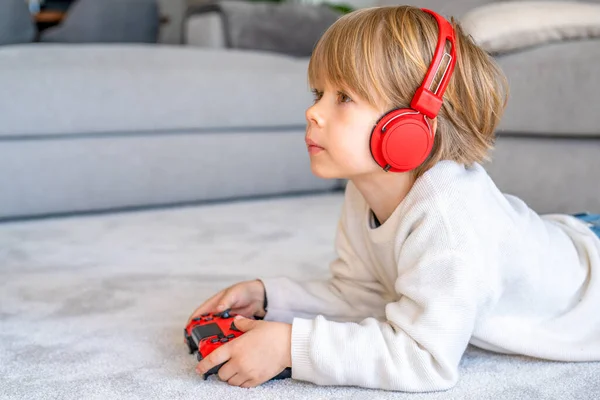 stock image Little boy playing video game console using joystick or controller while sitting at home real people family leisure concept