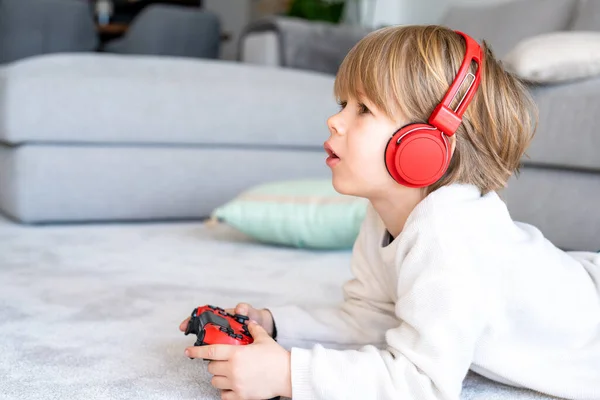 stock image Little boy playing video game console using joystick or controller while sitting at home real people family leisure concept