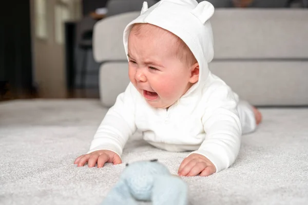 stock image childhood, babyhood and people concept - little baby boy or girl crying lying on floor at home