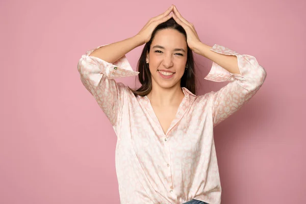 stock image Cheerful beautiful woman celebrating, looking with disbelief and excitement as winning prize, cheering like champion, screaming from good news and triumphing, pink background.