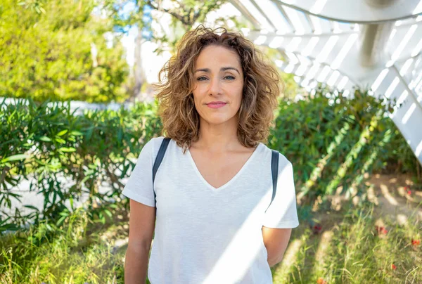 stock image Portrait of young woman with curly hair in the city