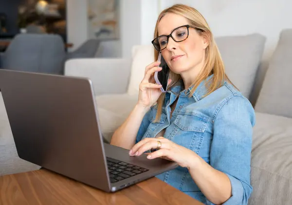 Beautiful female wearing casual clothes while working from home. Home office.