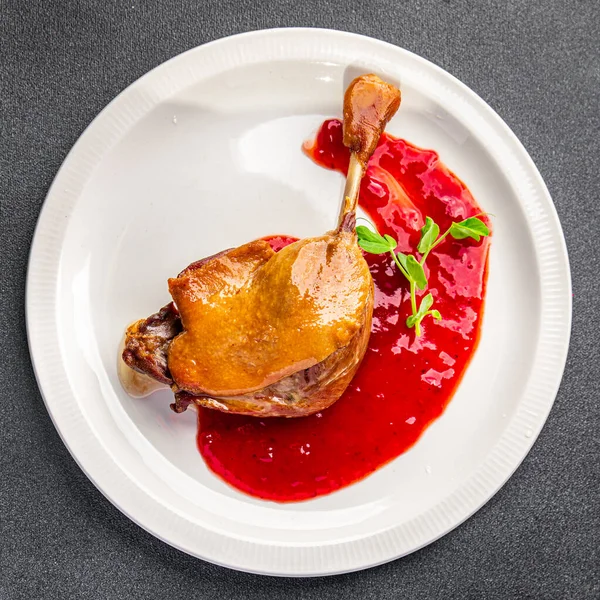 duck confit meat leg, red berry sauce  meal food snack on the table copy space food background