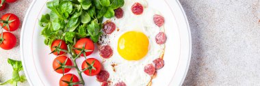 fried egg sausages, vegetable breakfast fresh meal food snack on the table copy space food background rustic top view