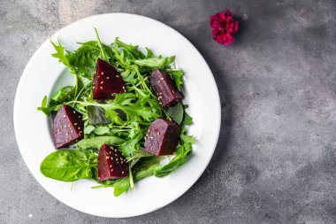 beet salad beetroot pieces mix green lettuce healthy meal food snack on the table copy space food background rustic top view keto or paleo diet veggie vegan or vegetarian food