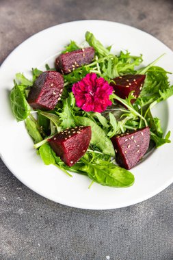 beet salad beetroot pieces mix green lettuce healthy meal food snack on the table copy space food background rustic top view keto or paleo diet veggie vegan or vegetarian food