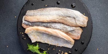 herring salted fish fillet fresh seafood healthy meal food snack on the table copy space food background rustic top view