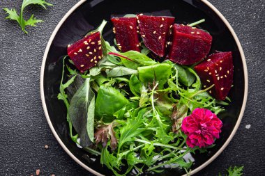 beet salad beetroot pieces mix green lettuce healthy meal food snack on the table copy space food background rustic top view