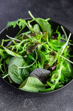 green salad leaves mix micro green, juicy healthy snack food on the table copy space food background rustic top view