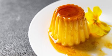 flan sweet dessert cream, caramel, lemon healthy meal food snack on the table copy space food background rustic top view