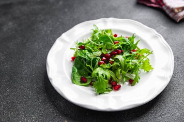 pomegranate seed salad green leaves lettuce mix healthy meal food snack on the table copy space food background rustic top view keto or paleo diet veggie vegan or vegetarian food