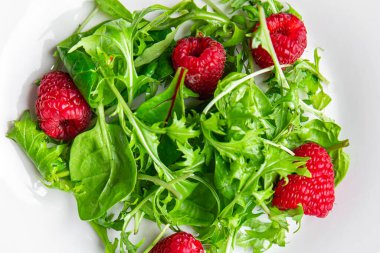 raspberry salad green leaves mix salad healthy meal food snack on the table copy space food background rustic top view keto or paleo diet veggie vegan or vegetarian food