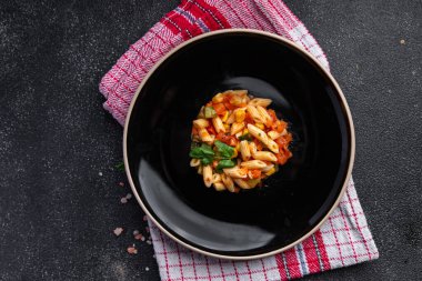 pasta salad tomato, cucumber, corn, vegetable, penne pasta meal food snack on the table copy space food background rustic top view 
