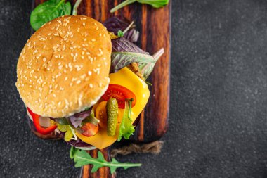 veggie burger cutlet vegetable meat, tomato, gherkin, lettuce healthy meal food snack on the table copy space food background rustic top view keto or paleo diet veggie vegan or vegetarian food