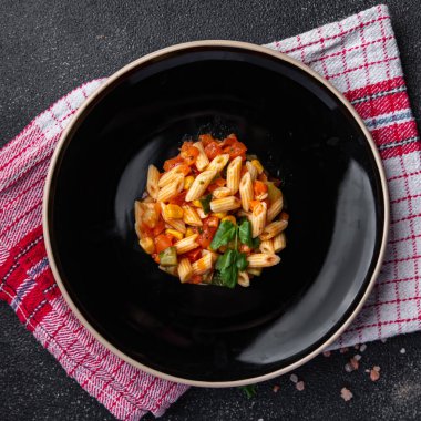 fresh pasta salad tomato, cucumber, corn, vegetable, penne pasta meal food snack on the table copy space food background rustic top view 