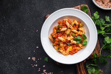 fresh pasta salad tomato, cucumber, corn, vegetable, penne pasta meal food snack on the table copy space food background rustic top view 