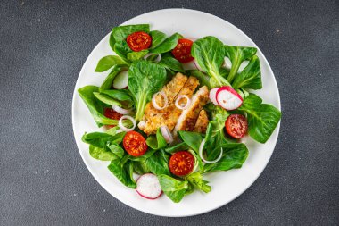fresh salad chicken meat, vegetable, tomato, radish, green leaves mix lettuce meal food snack on the table copy space food background rustic top view 