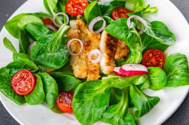 fresh salad chicken meat, vegetable, tomato, radish, green leaves mix lettuce meal food snack on the table copy space food background rustic top view 