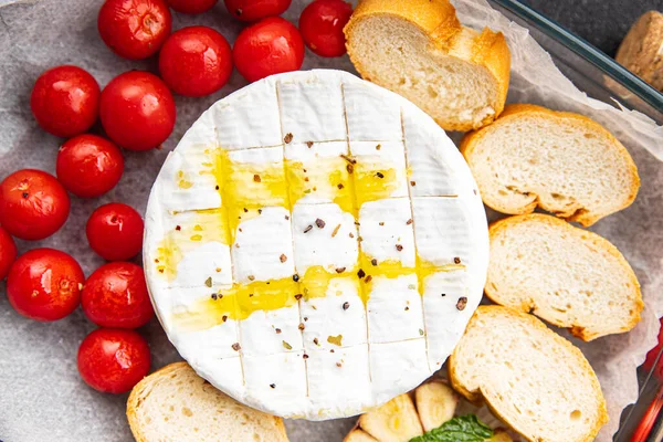 stock image cheese baked Brie or Camembert, tomato, garlic and herbs healthy meal food snack on the table copy space food background rustic top view