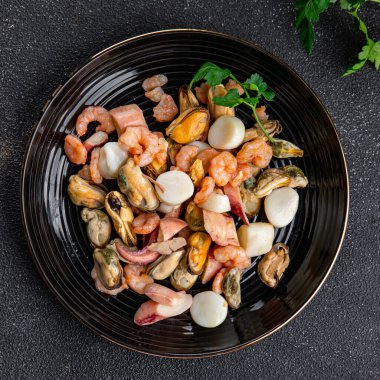 seafood salad shrimp, mussel, scallop, octopus healthy meal food snack on the table copy space food background rustic top view pescatarian diet