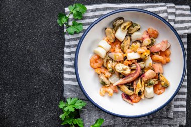 seafood salad shrimp, mussel, scallop, octopus healthy meal food snack on the table copy space food background rustic top view pescatarian diet