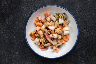 seafood salad shrimp, mussel, scallop, octopus healthy meal food snack on the table copy space food background rustic top view pescatarian diet