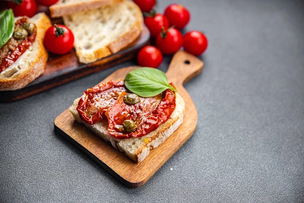 sun-dried tomato bruschetta healthy meal food snack on the table copy space food background rustic top view keto or paleo diet veggie vegan or vegetarian food
