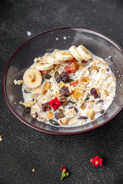 granola bowl with milk dried fruit and fresh banana tasty breakfast ready to eat healthy meal food snack on the table copy space food background rustic top view keto or paleo diet