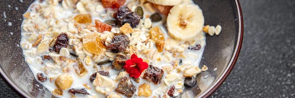 granola bowl milk, dried fruit and fresh banana tasty breakfast healthy meal food snack on the table copy space food background rustic top view