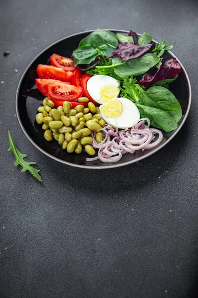 edamame bean salad vegetables, tomato, boiled egg appetizer meal food snack on the table copy space food background rustic top view